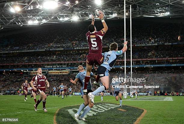 Israel Folau of the Maroons jumps high for the ball to score a try during match three of the ARL State of Origin series between the New South Wales...