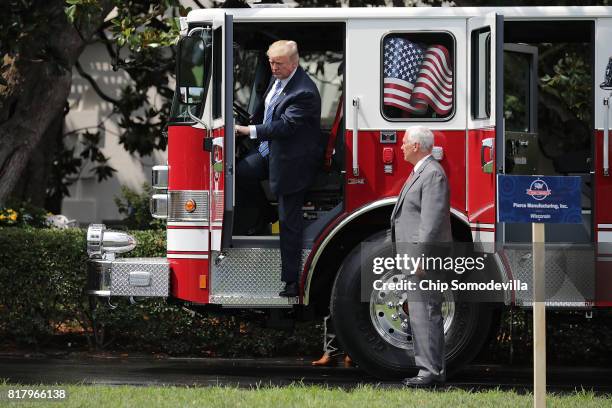 President Donald Trump steps out of a fire engine made by Pierce Manufacturing while touring a Made in America product showcase with Vice President...