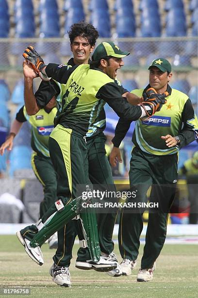 Pakistan cricketers Sarfraz Ahmed and Younus Khan congratulate teammate Abdur Rauf for the wicket of Indian cricketer Suresh Raina during the Super...