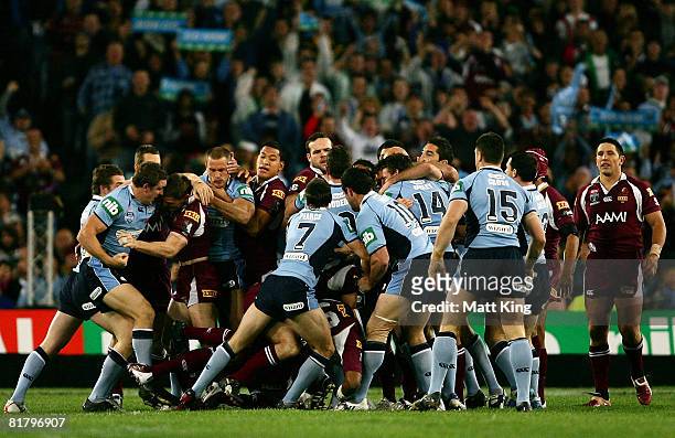 Players from both teams fight during match three of the ARL State of Origin series between the New South Wales Blues and the Queensland Maroons at...