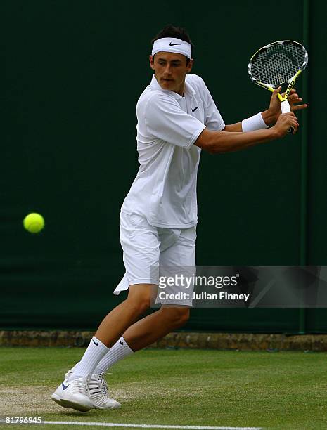 Bernard Tomic of Australia hits a backhand during the Boy's Singles third round match against Marcus Willis of Great Britain on day nine of the...