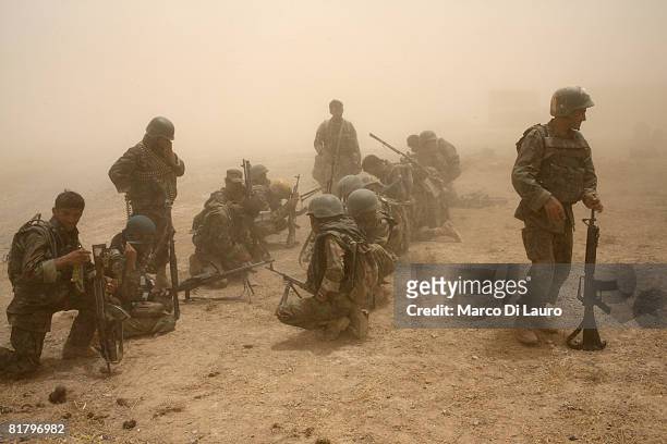 Members of the Afghan Security Forces wait to be extracted by helicopter after an operation to search three compounds and look for weapons on July 1,...