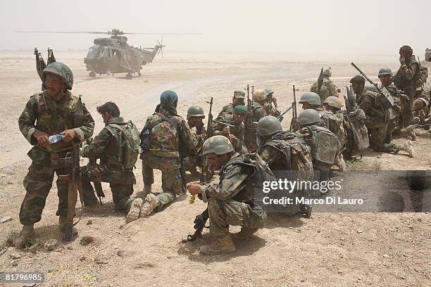 Members of the Afghan Security Forces wait to be extracted by helicopter after an operation to search three compounds and look for weapons on July 1,...