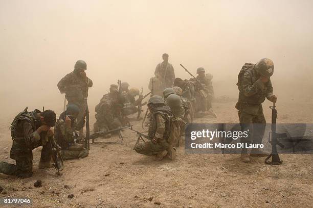 Members of the Afghan Security Forces wait to be extracted by helicopter after an operation to search three compounds and look for weapons on July 1,...