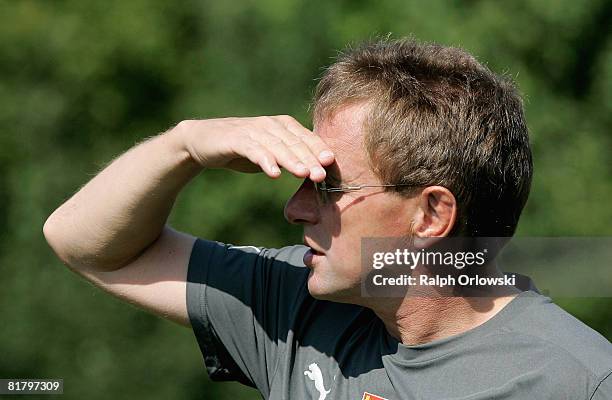 Ralf Rangnick, head coach of TSG 1899 Hoffenheim shades his eyes from the sun during a training session at their training camp on July 2, 2008 in...