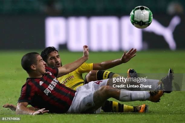 Nuri Sahin of Borussia Dortmund competes for the ball with Jose Mauri of AC Milan during the 2017 International Champions Cup football match between...