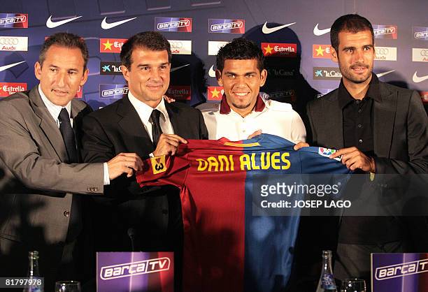 Barcelona's director of football Txiki Begiristain, President Joan Laporta, new signing Brasilian Dani Alves and coach Pep Guardiola pose on July 2,...