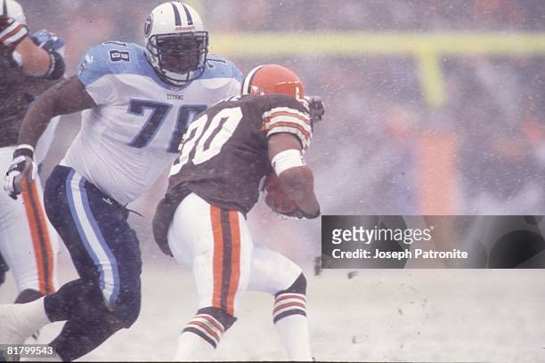 Defensive lineman John Thornton of the Tennessee Titans closes in on running back Jamel White against the Cleveland Browns at Cleveland Browns...