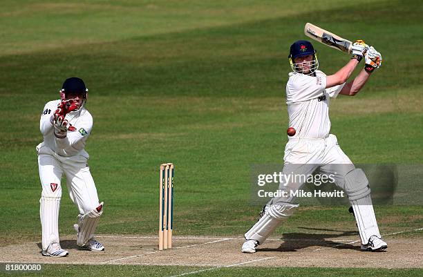 Andrew Flintoff of Lancashire hits out on his way to 50 as wicketkeeper Matt Prior of Sussex looks on during the LV County Championship match between...