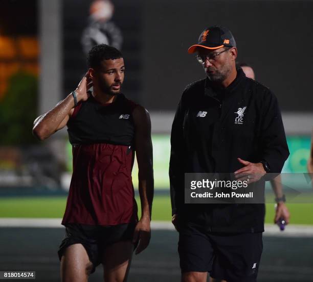 Jurgen Klopp manager of Liverpool talks with Kevin Stewart during a training session on July 18, 2017 at the Tseung Kwan O Sports Ground, Hong Kong.