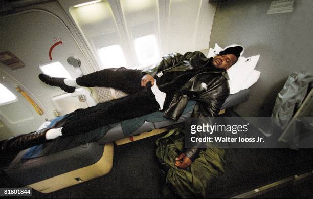 Basketball: Portrait of Los Angeles Lakers Shaquille O'Neal sleeping on airplane during team charter flight, 1/1/2002--3/18/2002