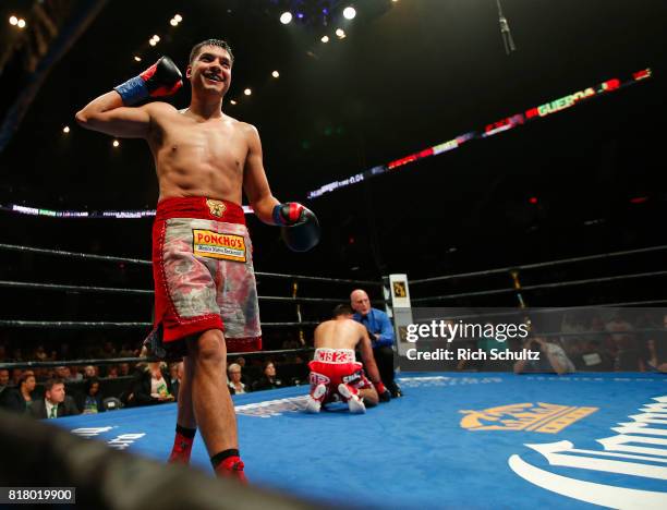 Omar Figueroa Jr., raises his arms after knocking Robert Guerrero down to the canvas for the third time during the second round of their Welterweight...