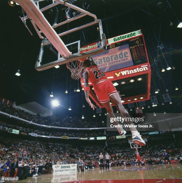 Basketball: NBA Slam Dunk Contest, Chicago Bulls Michael Jordan in action, making dunk during All Star Weekend, View of scoreboard at Chicago...