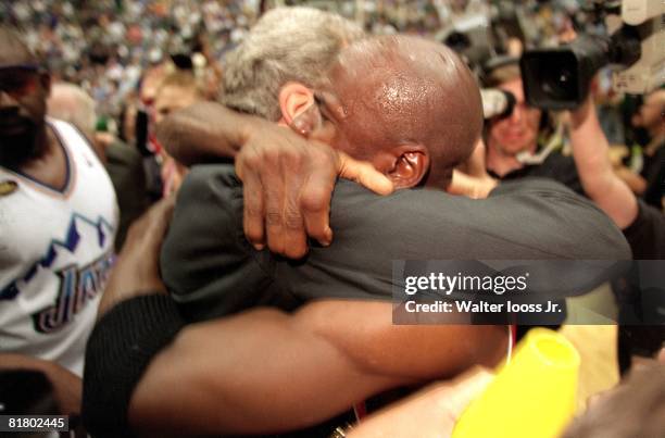 Basketball: finals, Closeup of Chicago Bulls coach Phil Jackson and Michael Jordan victorious, hugging after winning game vs Utah Jazz, Salt Lake...