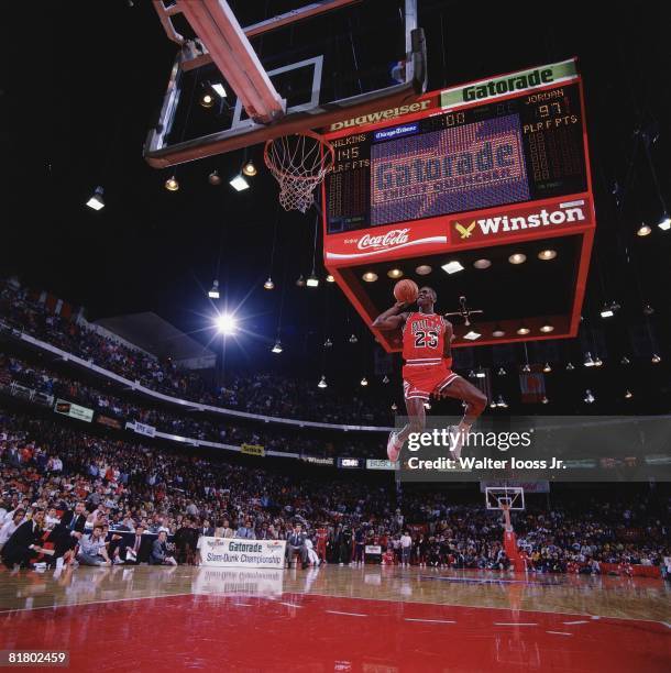 Basketball: NBA Slam Dunk Contest, Chicago Bulls Michael Jordan in action, making dunk during All Star Weekend, View of scoreboard at Chicago...