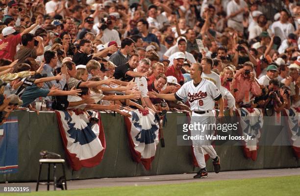 Baseball: Baltimore Orioles Cal Ripken Jr, victorious with fans, breaking Lou Gehrig's Record during game vs California Angels, Baltimore, MD 9/6/1995