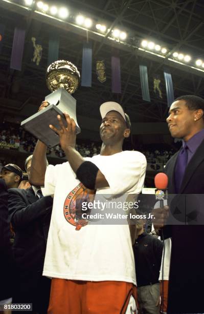 Basketball: NBA Finals, Chicago Bulls Michael Jordan victorious with sixth NBA Championship trophy and NBC Sports media announcer Ahmad Rashad after...
