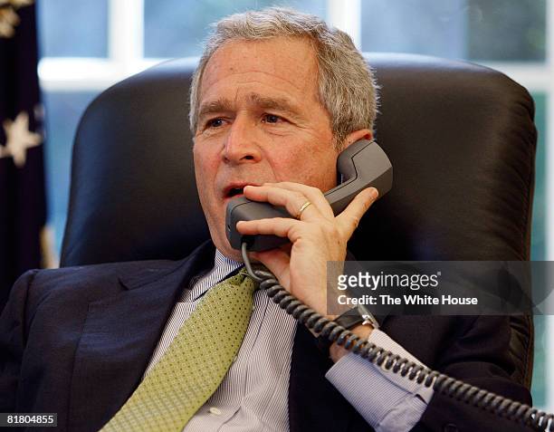 In this handout image provided by the White House, U.S. President George W. Bush speaks to Colombia's President Alvaro Uribe Velez on the phone after...
