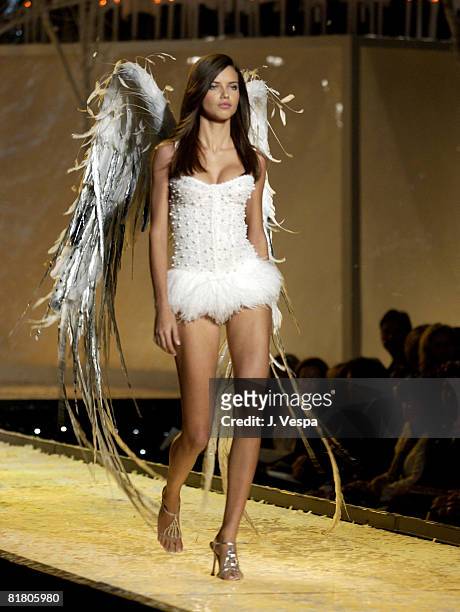 Adriana Lima wearing white Victoria's Secret beaded corset and white Victoria's Secret body bare shimmer bikini