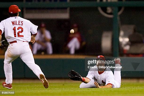 Ryan Ludwick and Aaron Miles of the St. Louis Cardinals attempt to catch a pop fly against the New York Mets at Busch Stadium July 2, 2008 in St....