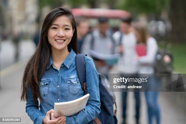 portrait of an asian student on the street looking at the camera smiling - chinese female university student portrait stock pictures, royalty-free photos & images