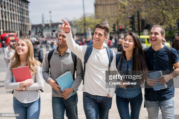 happy group of students walking outdoors in london - brown vs board of education stock pictures, royalty-free photos & images