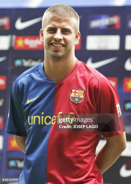 Barcelona's new signing football player Gerard Pique poses on July 3 at the Nou Camp stadium in Barcelona during his official presentation. Catalan...