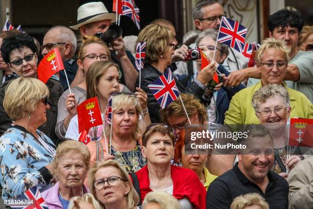 People welcoming Kate Middleton and Prince William with British and Gdansk City flags are seen in front of Artus Court in Gdansk, Poland on 18 July...