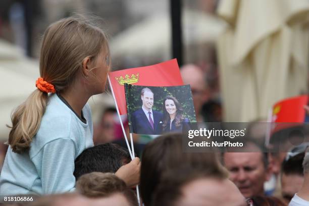 People welcoming Kate Middleton and Prince William with British and Gdansk City flags are seen in front of Artus Court in Gdansk, Poland on 18 July...
