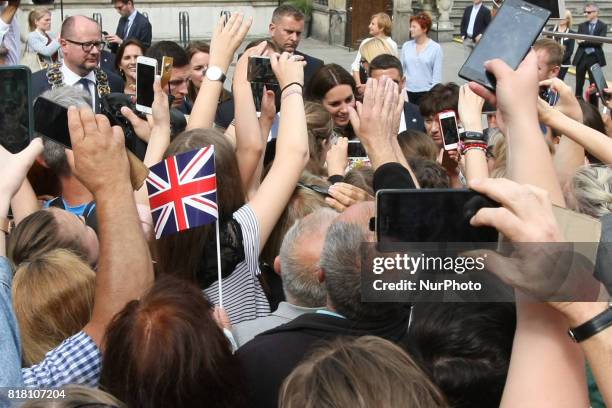 People welcoming Kate Middleton and Prince William with British and Gdansk City flags are seen in front of Artus Court in Gdansk, Poland on 18 July...