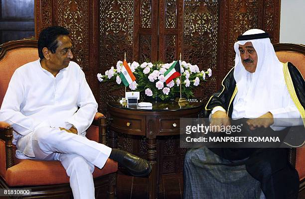 Minister of Finance of Kuwait Mustafa Jassim Al Shamali gestures as he chats with Indian Minister of Commerce and Industry Kamal Nath during their...