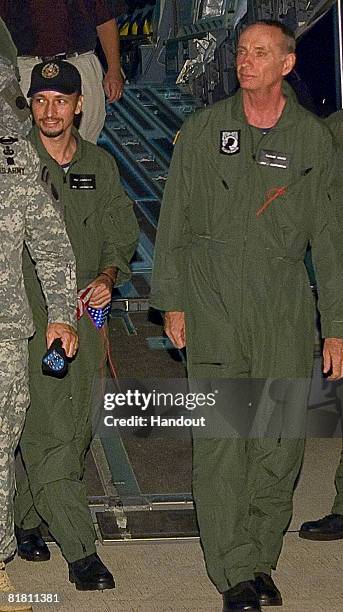 In a photo released by the U.S. Air Force, military contractors Mark Gonsalves and Thomas Howes step off an U.S. Air Force C-17 Globemaster III July...