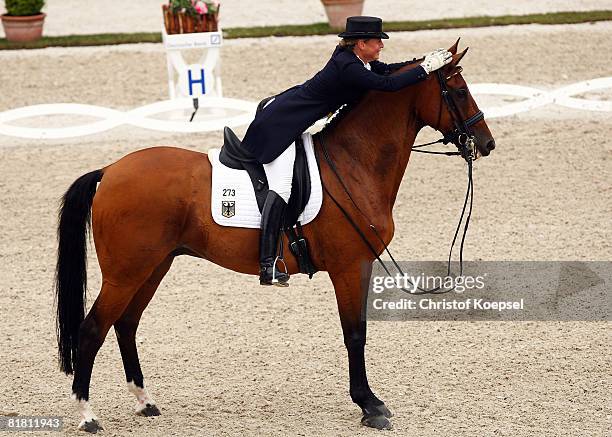 Isabell Werth of Germany rides on Satchmo and celebrates the first place of the Meggle prize Grand Prix of dressage on Day 2 of the CHIO Aachen on...