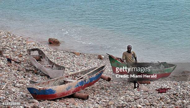 Fisherman prepares to head out on the water along the shore in Port Salut, Haiti in late June, nearly nine months after Hurricane Matthew struck the...