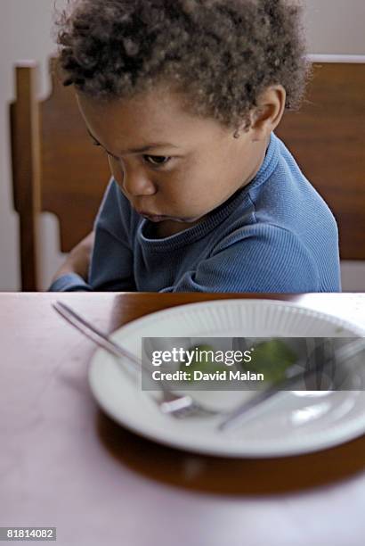 young boy refusing to eat broccoli, cape town, western cape province, south africa - picky eater stock pictures, royalty-free photos & images