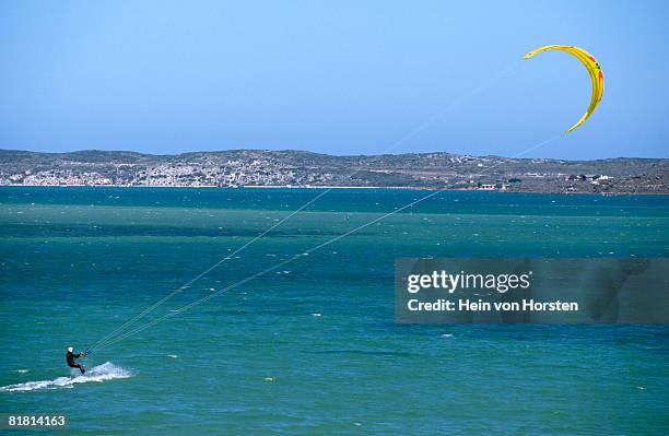 kite surfer in action on the langebaan lagoon in the western cape province, south africa - kite lagoon stock pictures, royalty-free photos & images