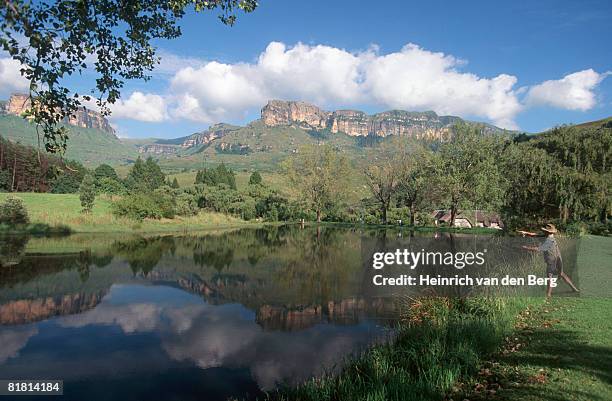 fly-fisherman fishing for trout in a dam in kwazulu natal drakensberg, south africa - freek van den bergh stock pictures, royalty-free photos & images