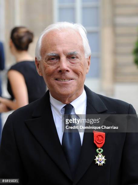 Italian fashion designer Giorgio Armani poses with his Legion of Honour award; France's most prestigious Legion D'Honneur medal, in the courtyard of...