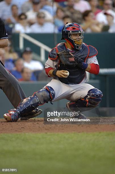 Catcher Yadier Molina of the St. Louis Cardinals fields his position as he looks to the runner on base after receiving the pitch from the pitcher...