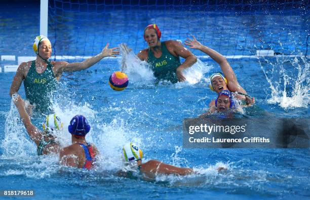 The Australian defence scrambles as Maria Borisova of Russia shoots on goal during the Women's Water Polo, Group D preliminary round match between...
