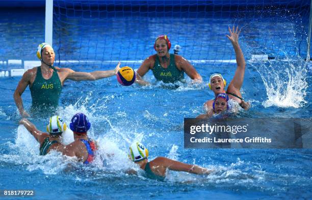 The Australian defence scrambles as Maria Borisova of Russia shoots on goal during the Women's Water Polo, Group D preliminary round match between...