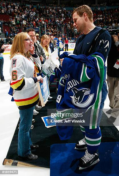 Markus Naslund gives his jersey to a fan during his last game as a Vancouver Canuck during their game against the Calgary Flames at General Motors...