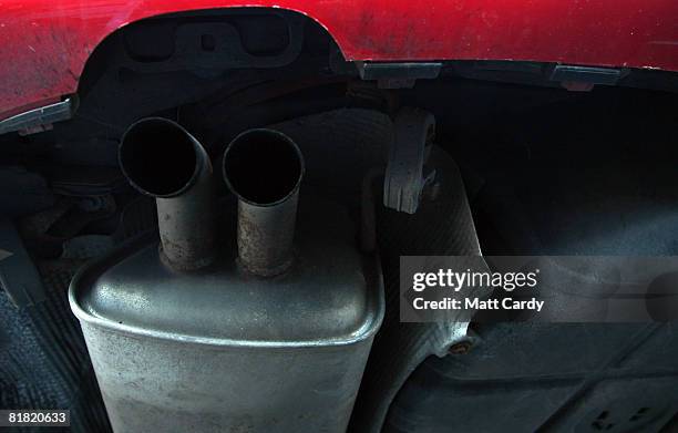 Rust spots gather on the exhaust pipe of a second hand car for sale parked on a used car lot on July 4 2008 in Bristol, England. The value of second...