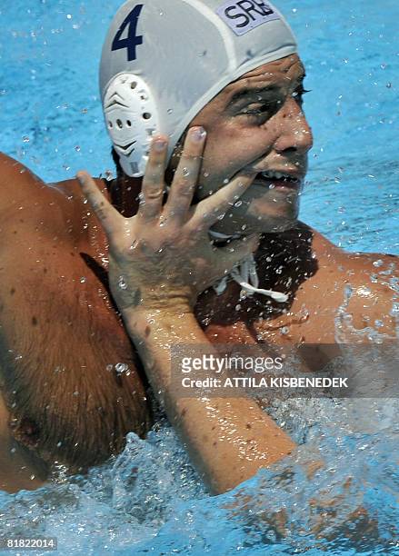 Serbian Vanja Udovicic is fouled by German Andreas Schlotterbeck in the aquatic center swimming pool of Spanish seaside town Malaga on July 4, 2008...