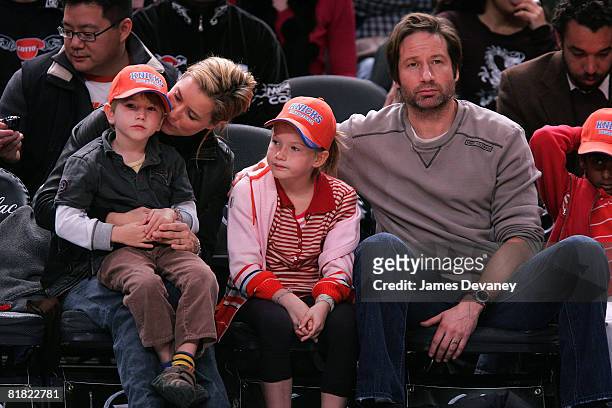 A Leoni and David Duchovny with their children attend Minnesota Timberwolves vs NY Knicks basketball game at Madison Square Garden in New York City...