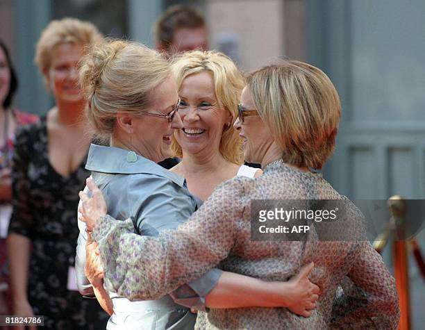 Actress Meryl Streep gets a hug from original Abba members Agnetha Faltskog and Annifrid Reuss at the Swedish premiere of the movie Mamma Mia in...