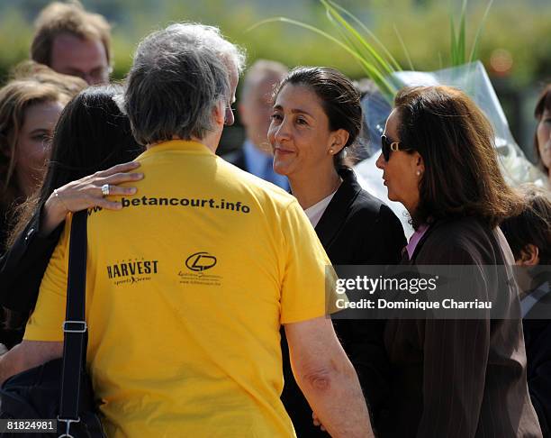 Ingrid Betancourt looks at an unidentified member of her support committee during the arrival ceremony at military base of Villacoublay on July 4,...