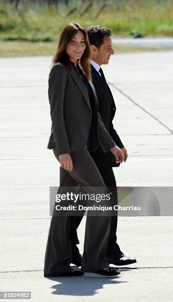 President Nicolas Sarkozy and first lady Carla Bruni-Sarkozy of France await the arrival by plane of freed hostage Ingrid Betancourt at the military...