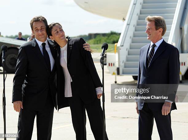 Freed hostage Ingrid Betancourt is accompanied by French president Nicolas Sarkozy and Bernard Kouchner on her arrival at the military base of...