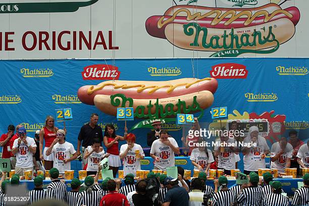 Competetors in the Nathan's Famous Fourth of July hot dog eating contest eat hot dogs July 4, 2008 in the Brooklyn borough of New York City. Chestnut...